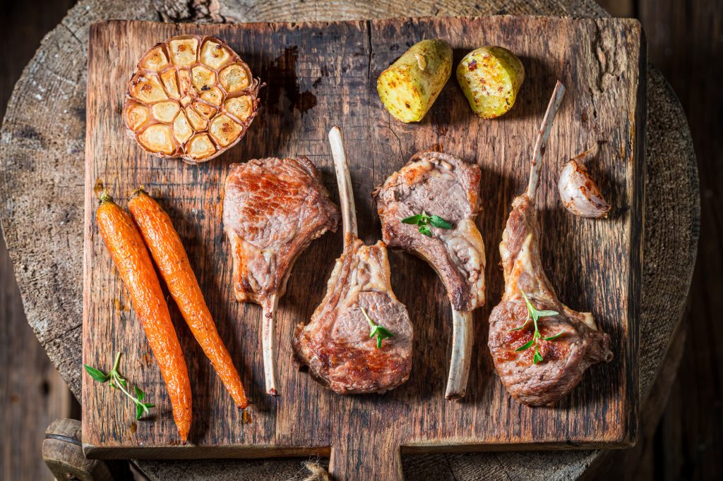 Top view of roasted lamb ribs with vegetables